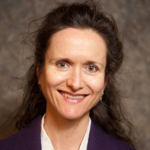 Headshot image of Fenella France wearing dark suit jacket and white top.