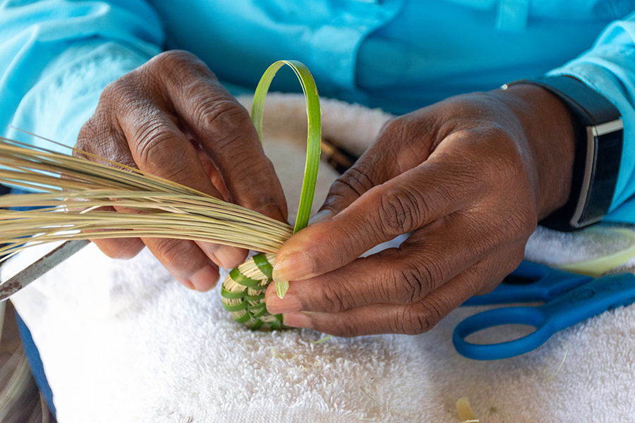 Gullah craftsperson weaving basket