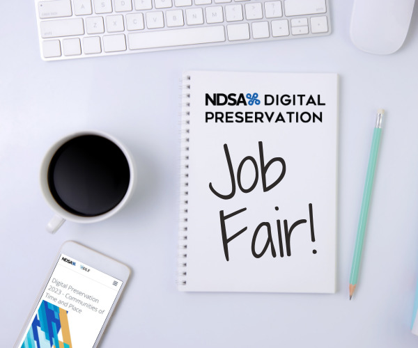 Color photo of top down view of white desk with white keyboard, full coffee mug, cell phone, and note pad. On note pad: NDSA DigiPres logo and handwritten words "Job Fair!"