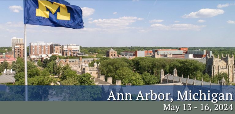 Color aerial photo of University of Michigan with university flag in forefront